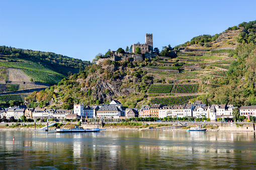 Kaub, Germany - August 08, 2022: Kaub in the Rhine valley Rhine valley. Visible rocks and sandbars due to extraordinary low water level after a long period of drought in 2022.