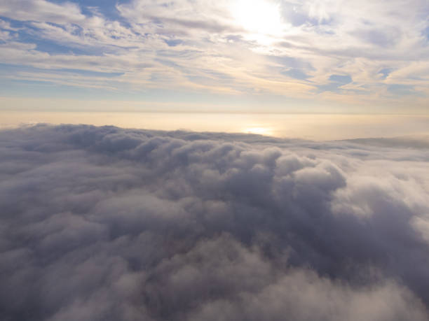 istock Beautiful sunrise above clouds view from airplane 1445243292