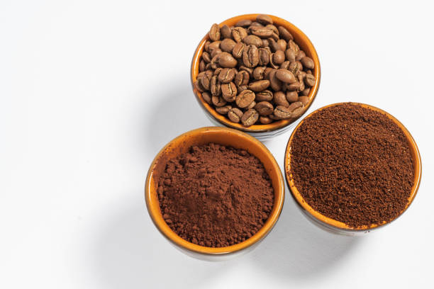 istock Cups with roasted coffee beans and ground coffee, white background and copy space. 1445243760