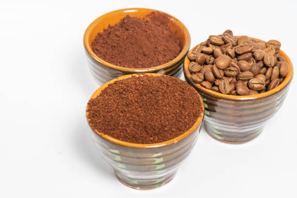 istock Cups with roasted coffee beans and ground coffee, white background and copy space. 1445243802