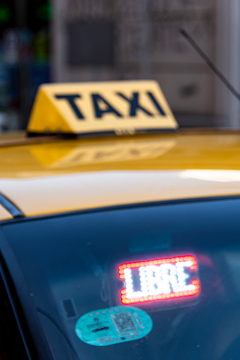 Taxi, its Signboard and Signal of free, or empty, slightly out of focus to dissimulate the taxi identification. Rosario city, Santa Fe province Argentina. November 23, 2022.