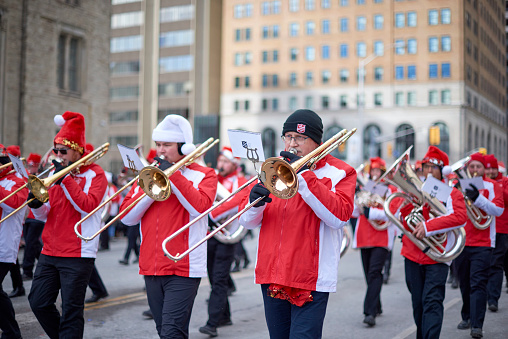 Toronto, Ontario, Canada- November 20th, 2022: A male member of the Salvation Army marching band playing the trombone in Toronto’s annual Santa Claus Parade.
