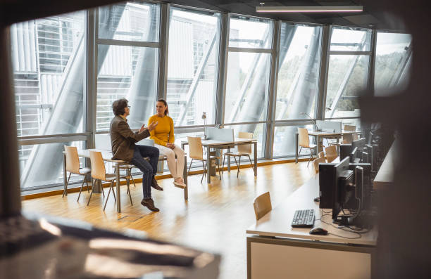 istock Two business people having a conversation in the office 1445249226