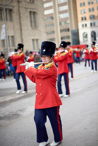 Toronto, Ontario, Canada- November 20th, 2022: A female member of the Burlington Teen Tour Band playing the flute during Toronto’s annual Santa Claus Parade.