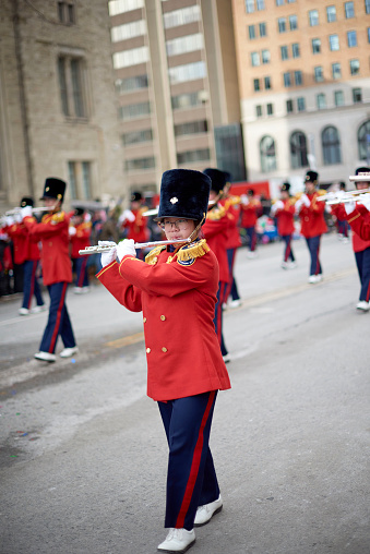Toronto, Ontario, Canada- November 20th, 2022: A female member of the Burlington Teen Tour Band playing the flute during Toronto’s annual Santa Claus Parade.
