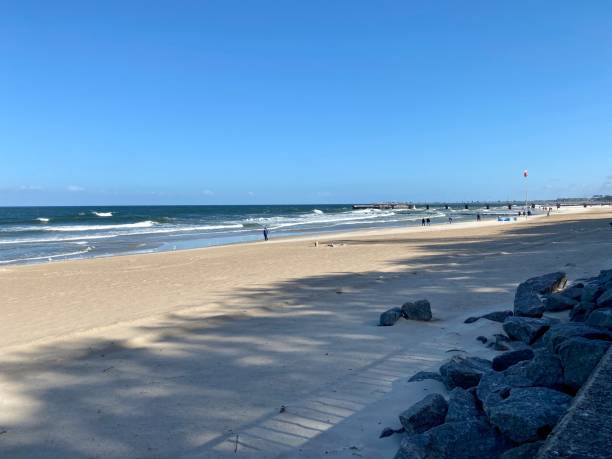 istock wide sandy beach blue sky with clouds visible waves over the baltic sea 1445251346