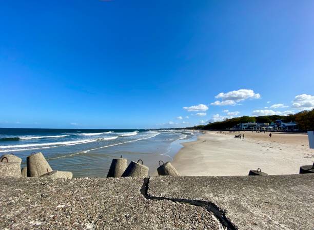 istock wide sandy beach blue sky with clouds visible waves over the baltic sea 1445252808