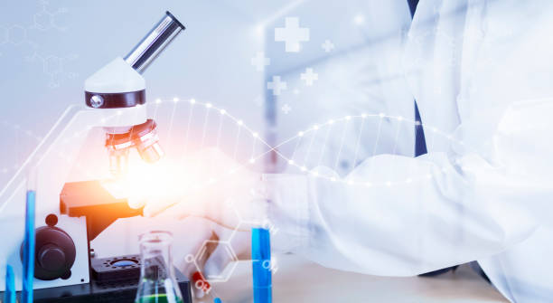 istock biochemical research scientist working with a microscope for the virus,Doctor man write a history of the experimental results in a , laboratory glassware containing chemical liquid for design. 1445252947