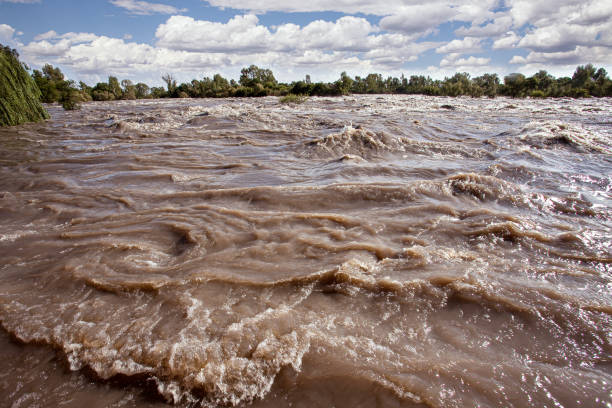 The Vaal River in flood. The Vaal River bisects the Vredefort astrobleme between the North-West and Free State Provinces. Shot in the UNESCO Vredefort Dome World Heritage Site, North-West Province, South Africa.