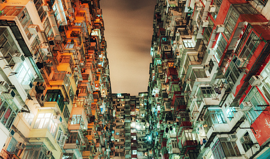 Yick Fat Building, Quarry Bay, Hong Kong. Residential area in old apartment with windows. High-rise building, skyscraper with windows of architecture in urban city.