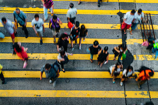 Pedestrians crossing street in Hong Kong, China