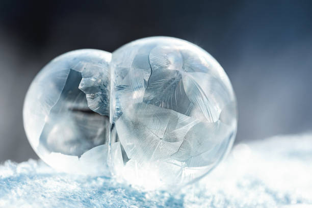 istock frozen bubble with bokeh background. Beautiful frosty patterns on frozen soap bubble 1445255276