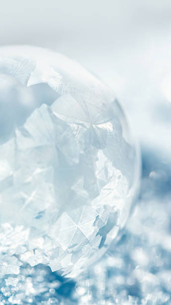 istock frozen bubble with bokeh background. Beautiful frosty patterns on frozen soap bubble 1445255306