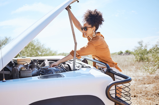 Black woman car engine problem on road trip or outdoor  holiday travel journey in Africa. Girl driver stop traveling, vacation and accident emergency assistance try fix or repair motor transportation