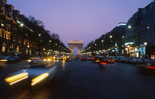Paris, Il de France, France, 1980. The Avenue de Champs Elysee at dusk.