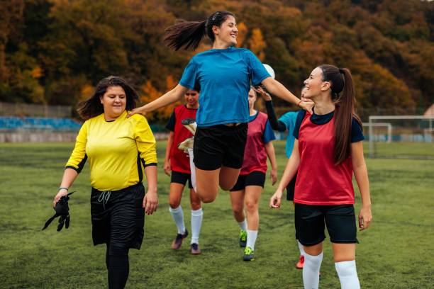 istock Joyful soccer player jumping on field. 1445260010