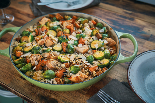 Preparing Farmers Harvest Chicken Casserole with Wild Rice, Brussel Sprouts, Kale, Onion and Sweet Potatoes