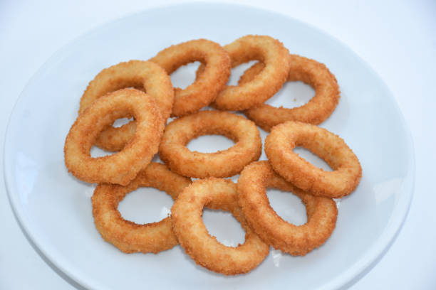 istock fried onion rings on white plate, isolated on white background 1445261128