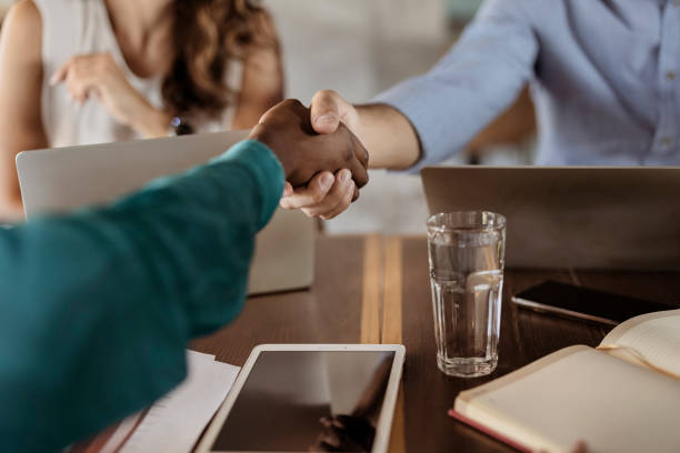 istock Businesspeople Shaking Hands in a Local Cafe 1445262901