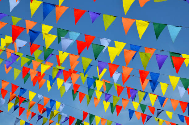 istock Multicolored triangular small flags to celebration party against blue sky.Street holiday concept. 1445264271