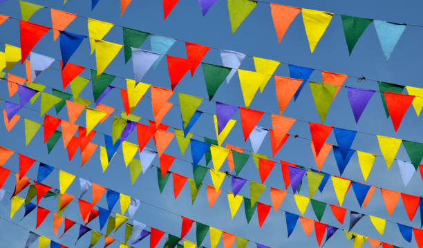 istock Multicolored triangular small flags to celebration party against blue sky.Street holiday concept. 1445264312