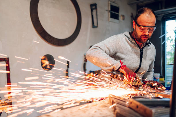 istock Worker in a factory grinding metal with a grinder 1445264644
