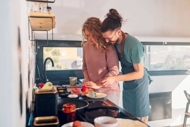 istock Young couple making breakfast together in the kitchen at home 1445264678