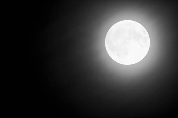 Full Moon and clouds on the night sky