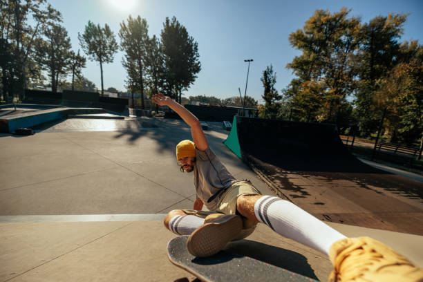 istock Skater sliding up ramp in skatepark. 1445266891