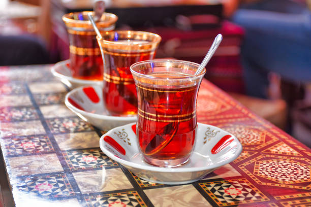 istock three tea glasses of traditional turkish tea and spoon on backgammon table 1445267099