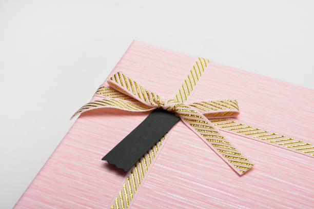 Gift box and empty gift tag with golden ribbon