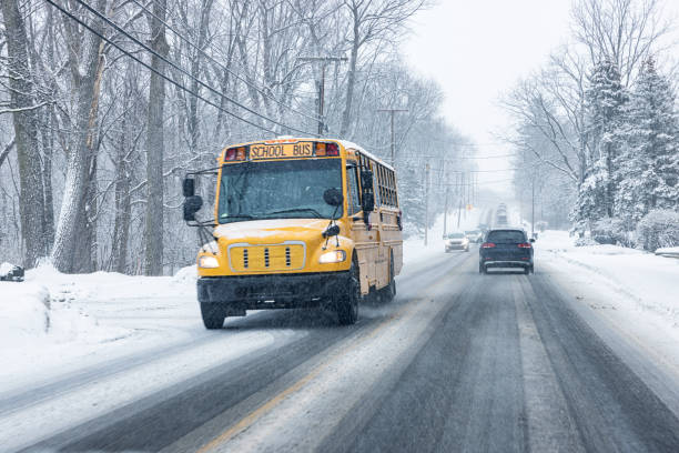 istock Winter Snow School Bus Driving on Slushy Highway 1445267976
