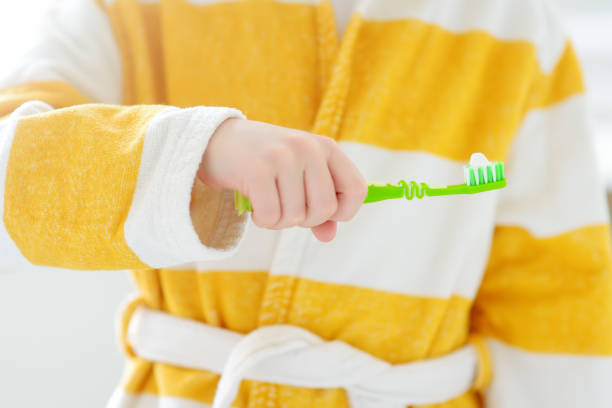 Cute child brushing teeth. Preschooler boy using toothbrush toothpaste and in bathroom during morning routine. Baby learning brush tooth. Equipments for kids dental and oral hygiene. Healthcare.