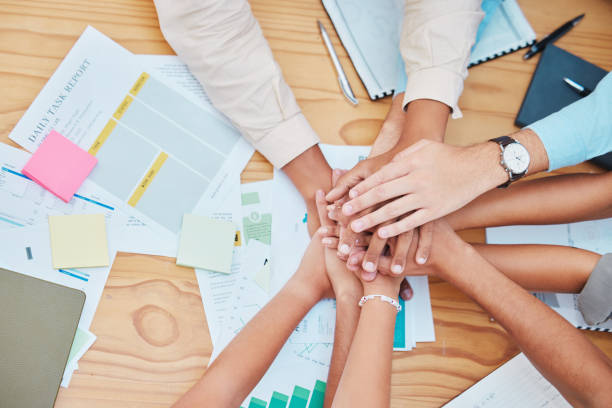 istock Team hands collaboration for success, celebration and support on a table in a office. Business teamwork and motivation to achieve a goal together during team building mission in a startup company 1445269682
