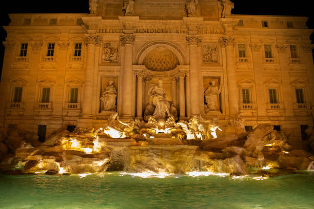 Experience the captivating beauty of the Trevi Fountain in Rome, Italy, as dusk settles over the city, highlighting its intricate Baroque architecture and the vibrant glow of the illuminated water.