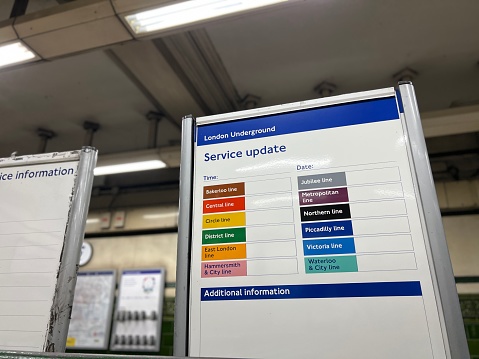 London, UK - 28 November, 2022: color image depicting a close up view of a passenger information sign in a London Underground tube station. The sign lists the different tube lines and whether there are delays affecting the transport service.