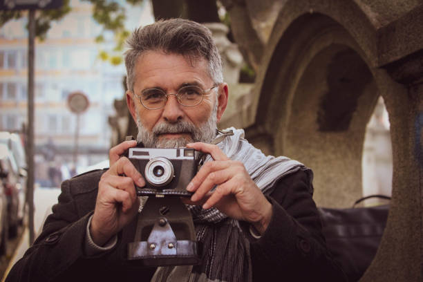 istock Retro senior man take a photos on street 1445274547
