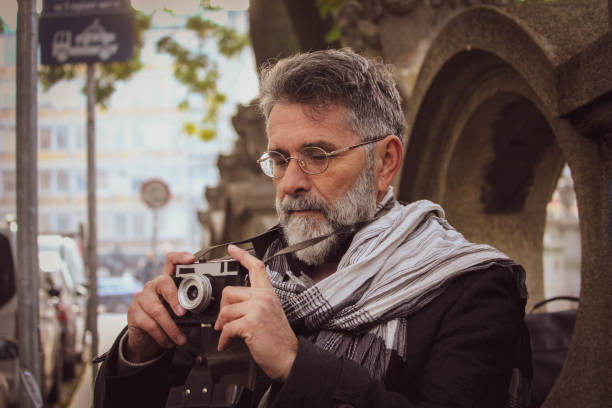 istock Retro senior man take a photos on street 1445274549