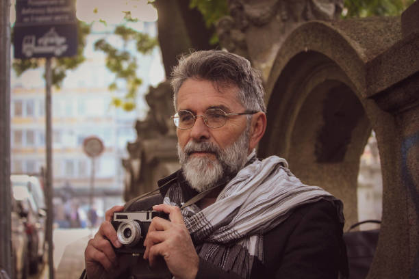 istock Retro senior man take a photos on street 1445274555