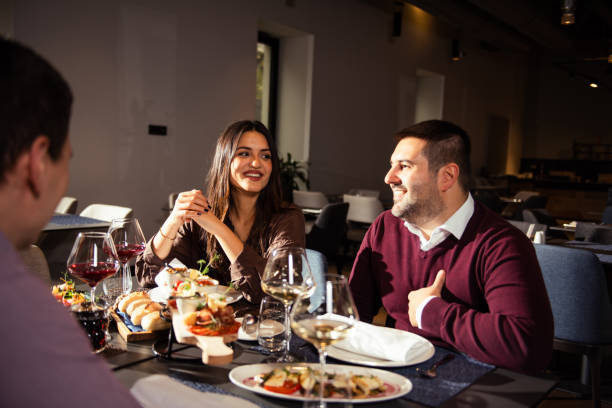 istock Happy business colleagues talking while eating lunch in a restaurant 1445274640