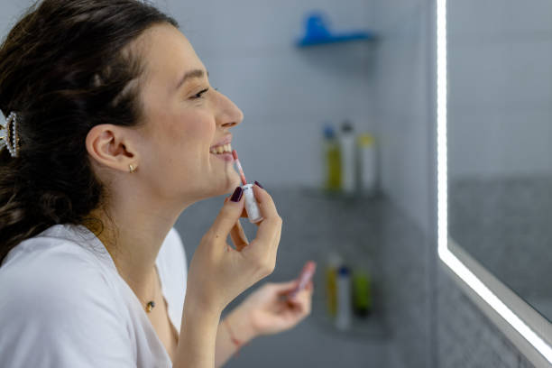 istock Woman applying some make up indoors 1445279474