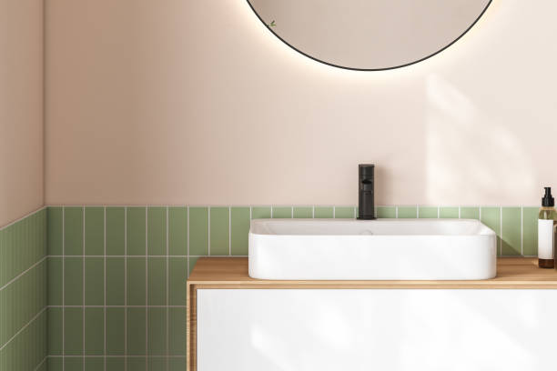 istock 3D render close up white vanity counter with ceramic washbasin and modern style faucet in a bathroom with morning sunlight and shadow. Blank space for products display mockup. Background, Wall tiles. 1445280159