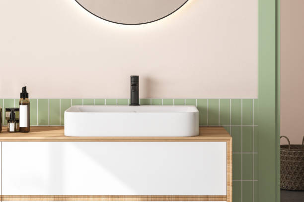 istock 3D render close up white vanity counter with ceramic washbasin and modern style faucet in a bathroom with morning sunlight and shadow. Blank space for products display mockup. Background, Wall tiles. 1445280162