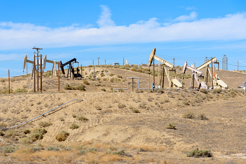 Pumpjacks in a oil field on a clear autumn day. Bakersfield, CA, USA.
