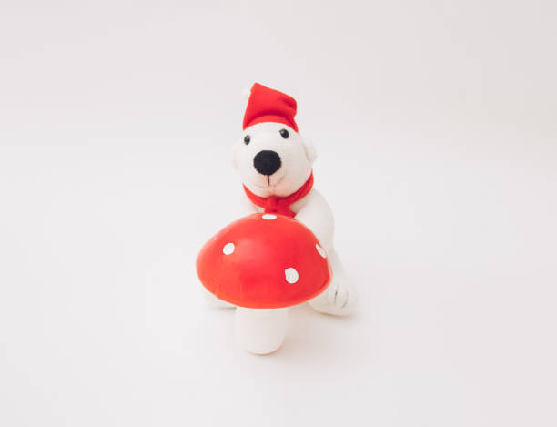 istock Polar bear with huge red mushroom na beloj pozadini. 1445280515