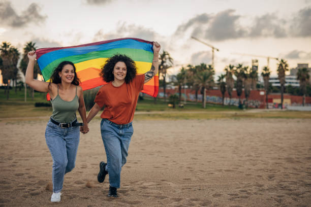 istock Lesbian couple holding rainbow flag 1445280703