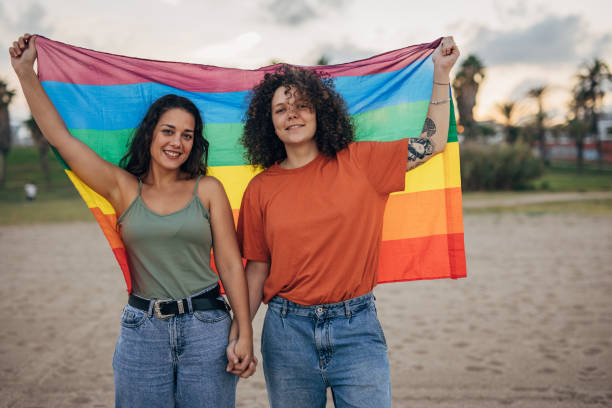 istock Lesbian couple holding rainbow flag 1445281246