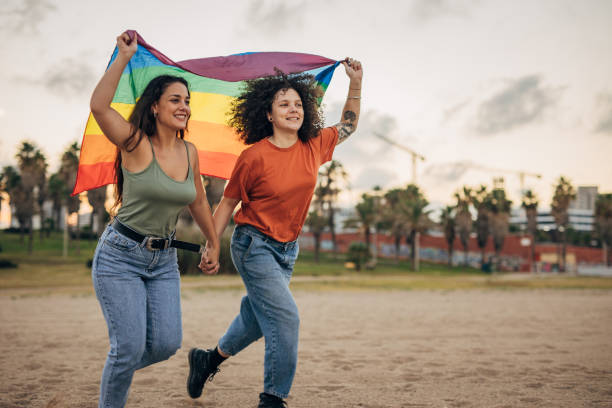 istock Lesbian couple holding rainbow flag 1445281345