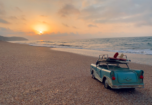 Blue toy car drive on the beach