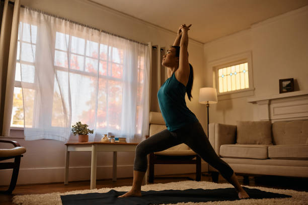 istock Asian female athlete doing relaxation exercises while working out at home. 1445288582